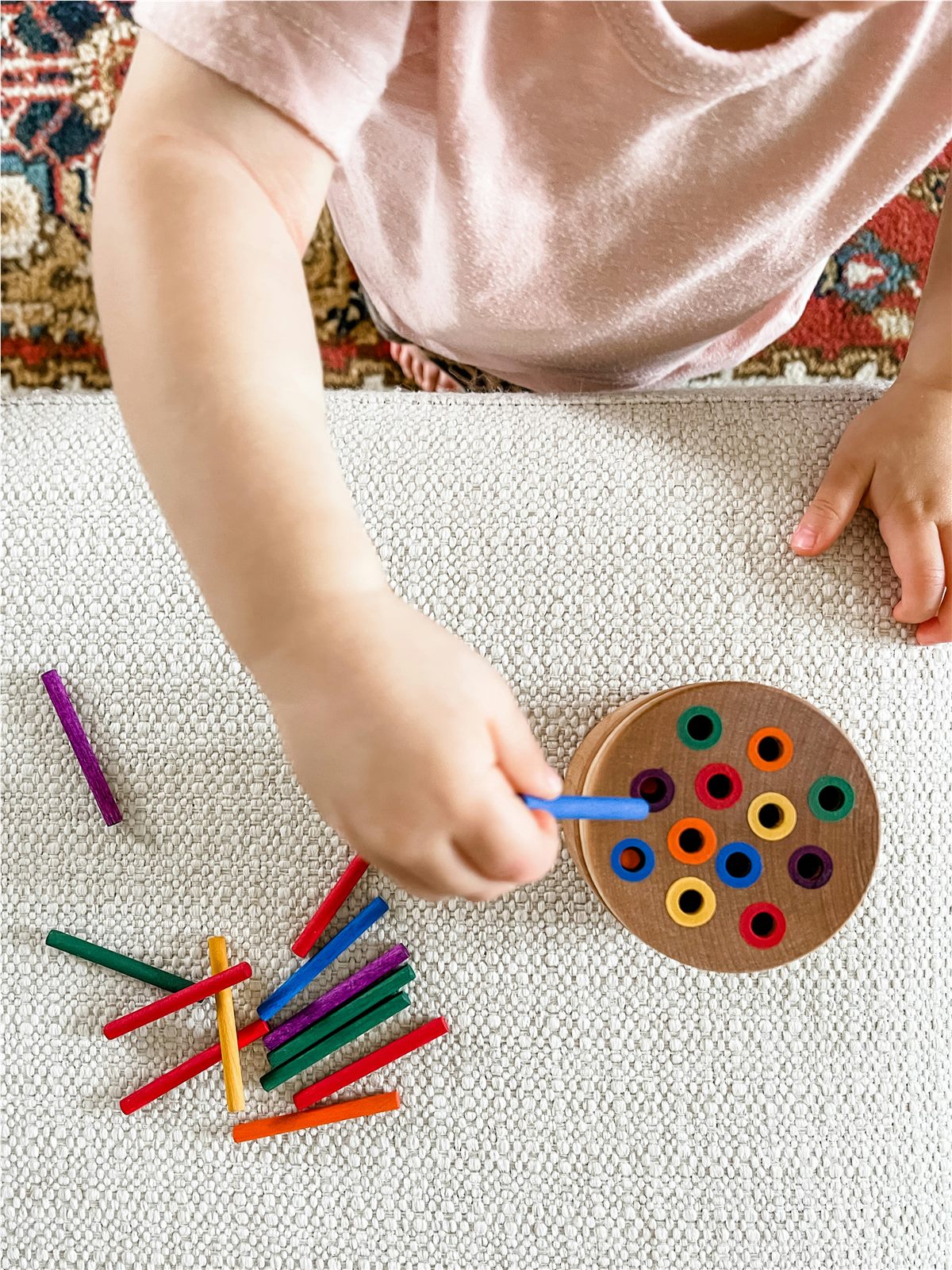 Toddler drawing with crayons during a Montessori activity in Mississauga